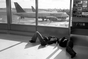 Tammy Rosemeyer, left, and Lone Pieper wait out a flight delay at Newark Airport after all flights were suspended at New York area airports after an American Airlines jet crashed into Queens in New York City Monday, Nov. 12, 2001. (Courtesy of krtcampus.com)
