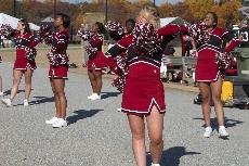 Guilfords cheerleaders encourage the crowd and lead the way in the first-ever homecoming parade around the football field on Nov. 8. (Mary Bubar)