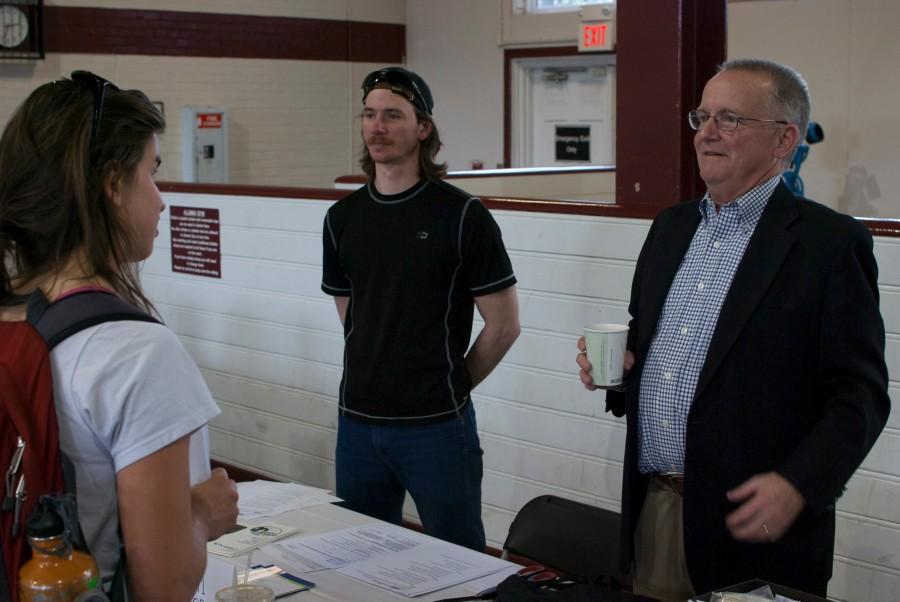 Senior Molly Gibbs learns about the National Alliance of Mental Illness (NAMI) from representative Jack Glenn, president of NAMI Guilford, at the Non-Profit Engagement Fair held in the Alumni Gym on March 16. (Talyor Shields)