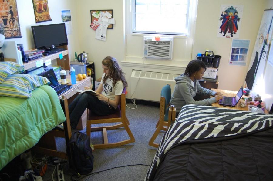 First-years Heather Nelson (left) and Taylor Alston  (right) do homework in their Milner Hall dorm room. (Kacey Minnick)