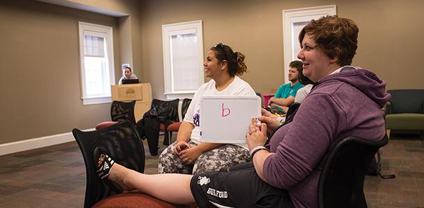 Students go over answers to another round of safe sex and healthy relationship trivia at one of the Consent Week events. 