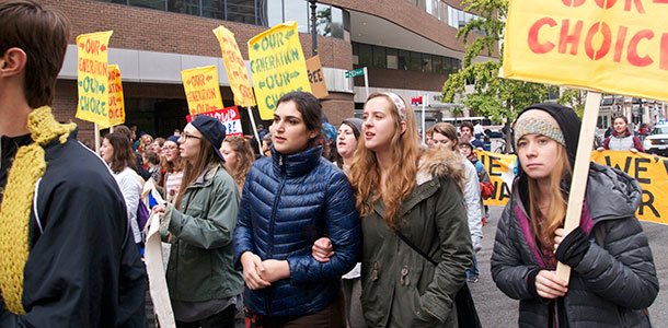 Junior Mara Stern, senior Maile Munroe and junior Becca Mellor march.