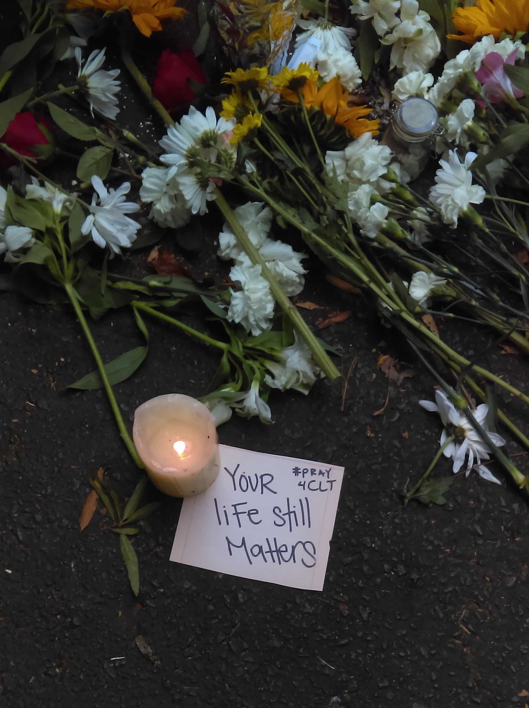 People left flowers and messages near the site where Keith Lamont Scott was killed. Courtesy of Gabe Pollack
