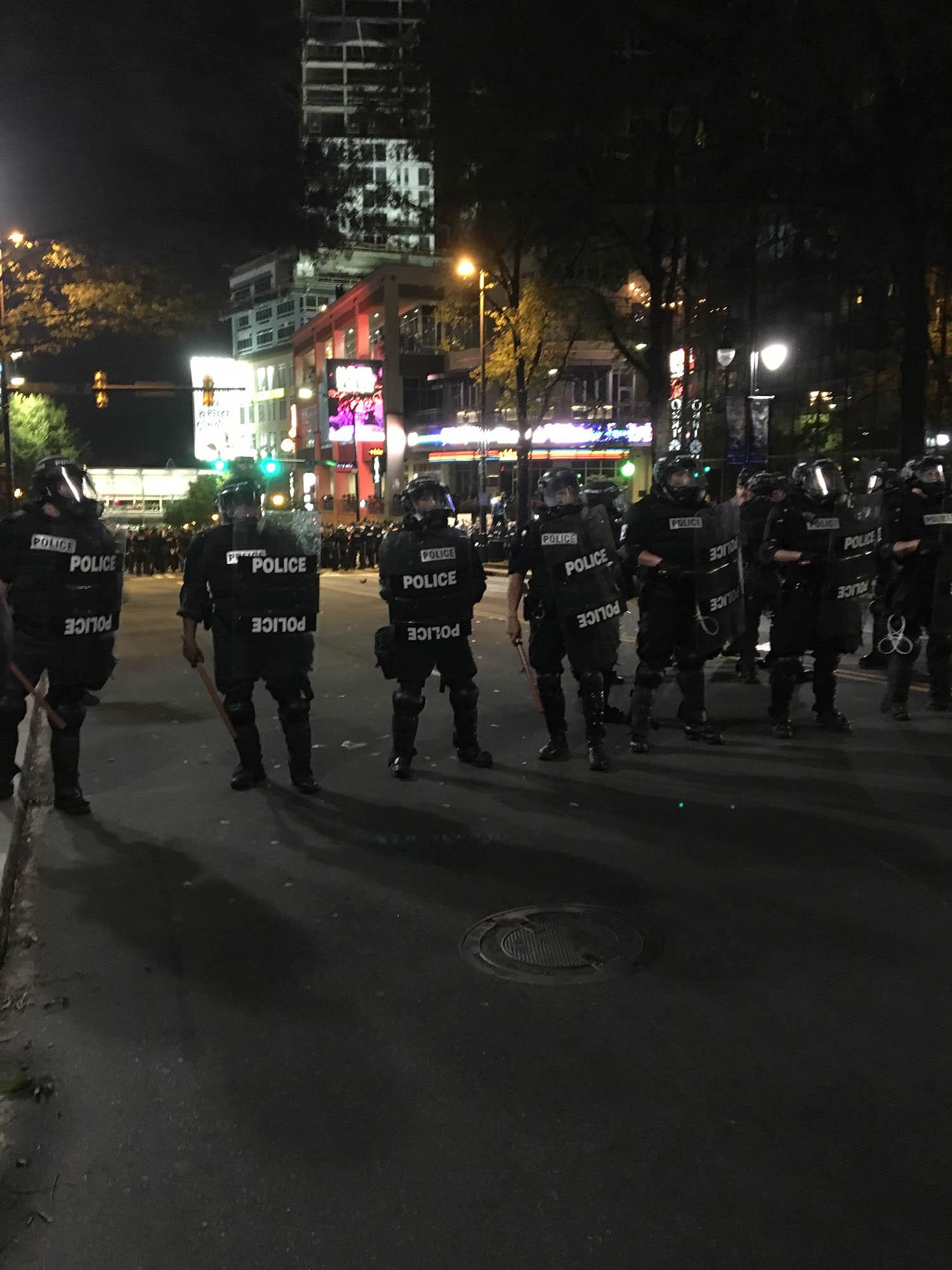 Police form a barrier in front of protesters, including Guilford College students, on North College Road in Charlotte on Sept. 21. Courtesy of Holly Haid