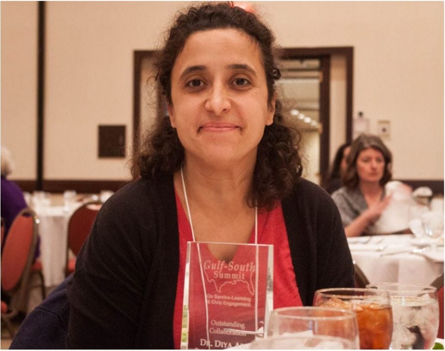 Diya Abdo, associate professor of English, receives the 2017 Outstanding Service-Learning Collaboration in Higher Education Award during the Gulf South Summit conference on Friday, March 24, 2017 in Greensboro, North Carolina. // Photo by Fernando Jimenez/Guilfordian.