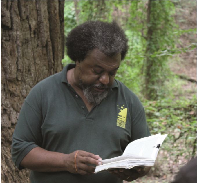 James Shields ‘00, director of The Bonner Center for Community Service & Learning, reads an excerpt from The Reminiscence of Levi Coffin in front of the Underground Railroad Tree. // Photo by Nicole Zelniker/Guilfordian