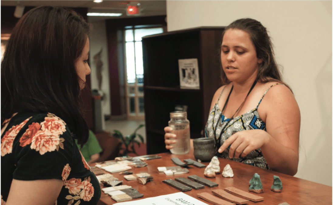 Abby Horn ’17, right, presents her research to Lesly Vasquez ‘18, left, at the Guilford Undergraduate Symposium on Friday, April 21, 2017 at Guilford College in Greensboro, North Carolina.