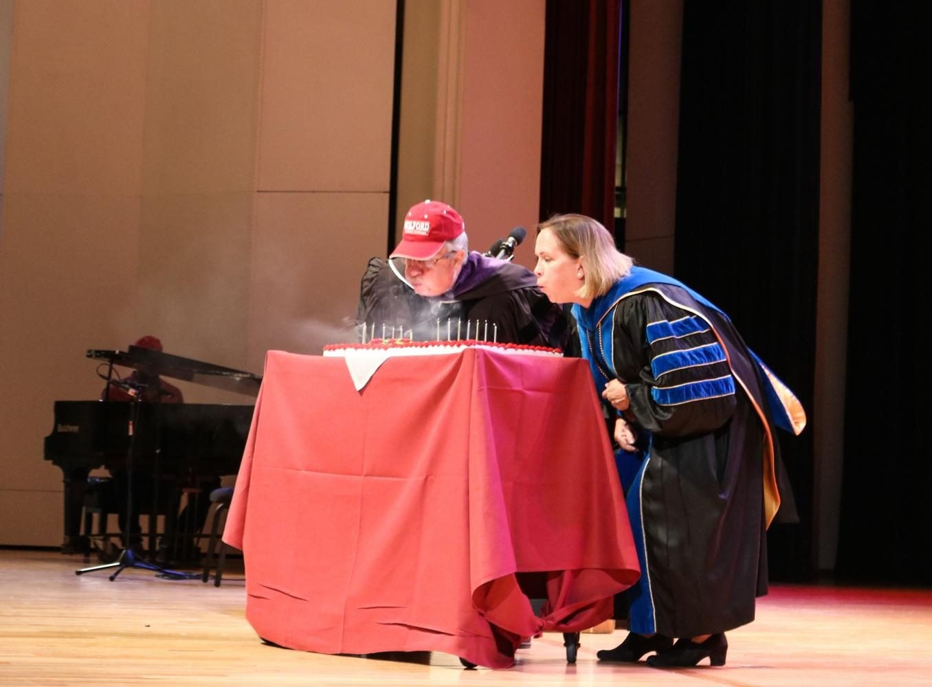 Left to right Edward C. Winslow III and President Jane K. Fernandes blow out candles in celebration of Guilford College’s 180th birthday. // Photo by Fernando Jimenez/The Guilfordian
