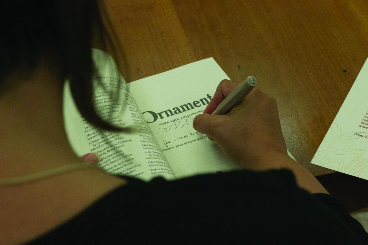 Anna Bell presented her book, “Ornament,” on Thursday, Sept. 28, 2017. Afterward, Bell signs and inscribes the books she sold.//Photo by Eric Xu /The Guilfordian