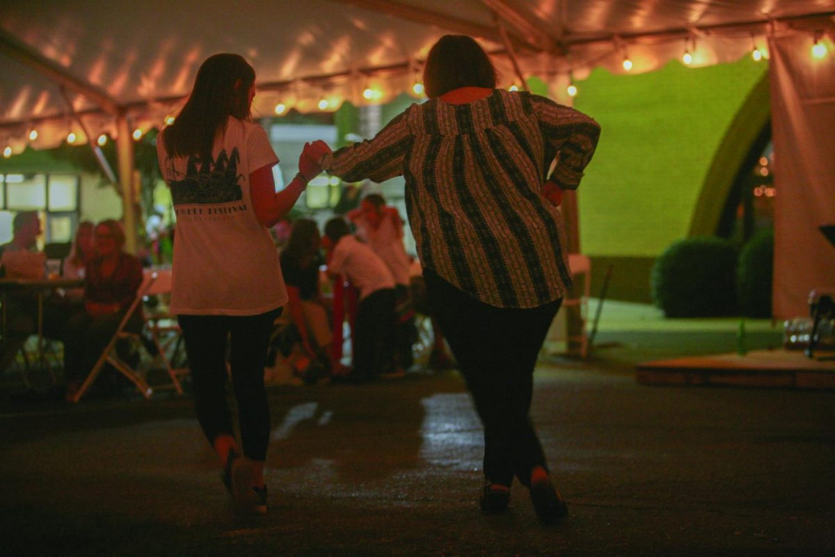 essica Oberlies, (left), and Betselot Tessema eat gyros and take a break from performing at the 2017 Greensboro Greek Festival.//Photo by Julia Martins de Sa/The Guilfordian