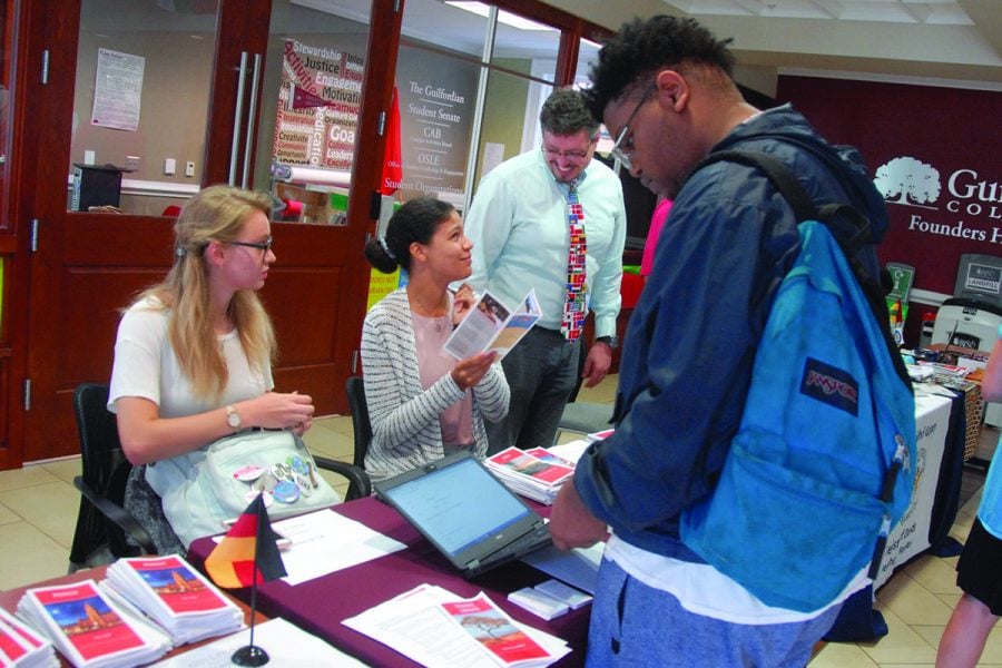 Arthur Jones receives information from Elizabeth Kapuscinski, Lila Jones, and Daniel Diaz during the Study Abroad Fair. // Photo By: Ezra Weiss/The Guilfordian