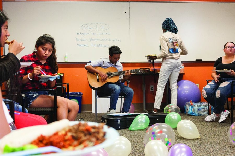 Sophomore Moe Reh plays the guitar at the beginning of HUG’s Welcome Back Celebration which took place on Wednesday, Aug. 29 in the MRC room in King Hall. The event featured traditional Latin American food and activities that allowed attendees to network and interact with each other. // Photo By: Fernando Jiménez/The Guilfordian