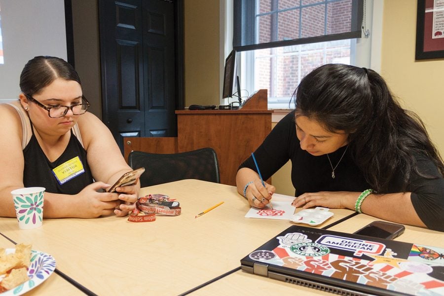 Junior Kendra Guzman and senior Jeniffer Gonzalez-Reyes paint canvases and have a conversation regarding culture on Wednesday, Sept. 26 in King Hall. // Photo By: Fernando Jiménez/The Guilfordian
