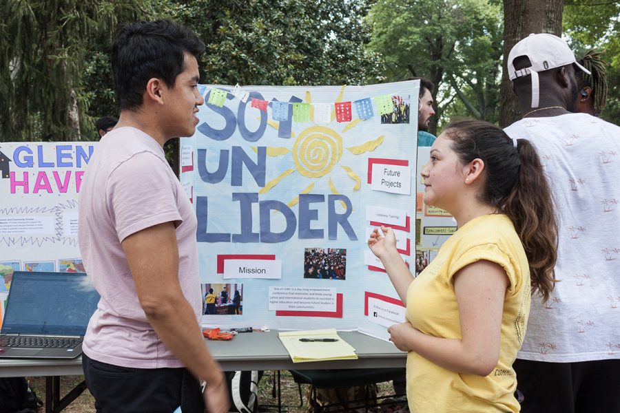 Sophomore Gerardo Osorio Monzon learns about the Soy un Lider conference from sophomore Daisy Arguello who is the student coordinator of the volunteer site. // Photo By: Fernando Jiménez/The Guilfordian