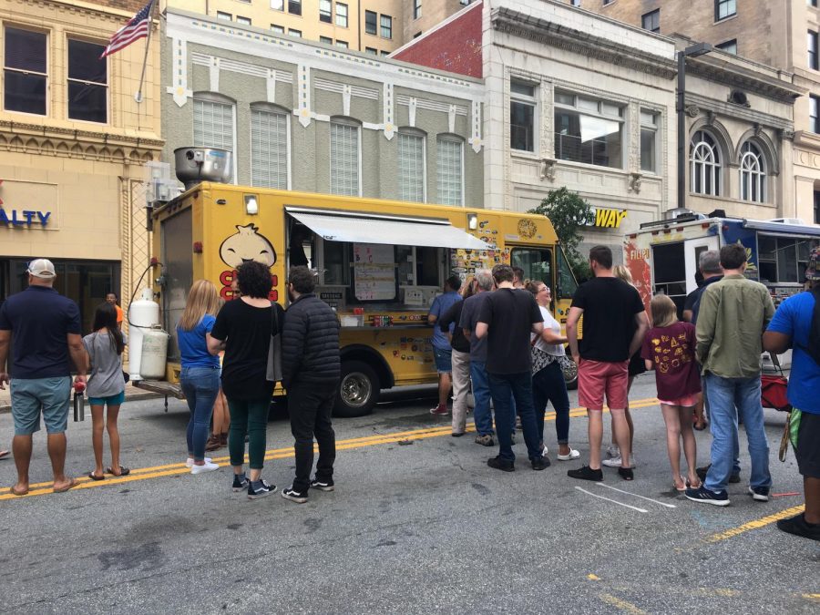 Community members patiently line up to order food at the wide array of different food trucks at the festival.