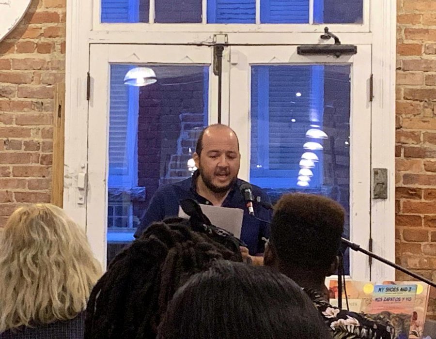 Writer Oswaldo Estrada, a UNC-Chapel Hill professor of Spanish and Latin American Studies, reads at Scuppernong Books during the Writers for Migrant Justice event on Sept. 4.