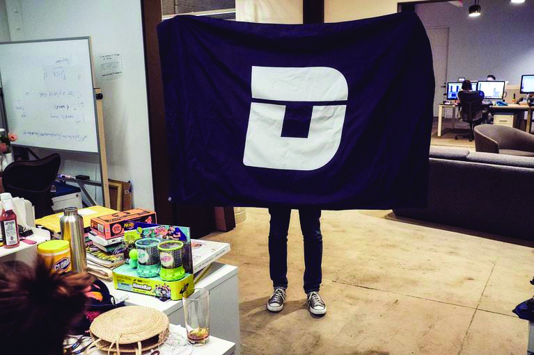 A Deadspin employee displyays the site’s logo.