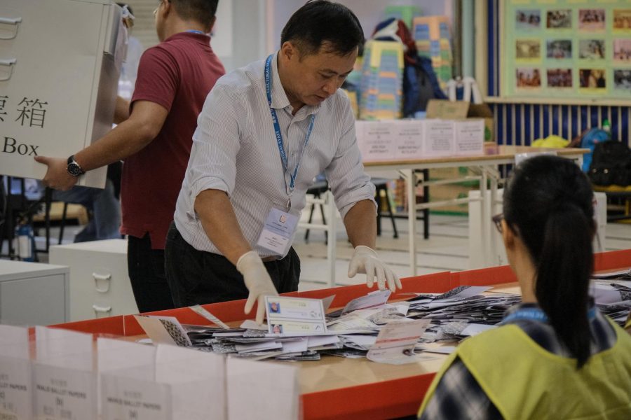 An official counts voting ballots after the district council elections on Nov. 24. Many pro-democracy politicians were elected. 