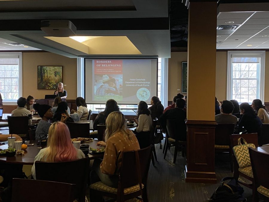 Attentive audience members listen to Castañeda as she presents her findings about mixed families.