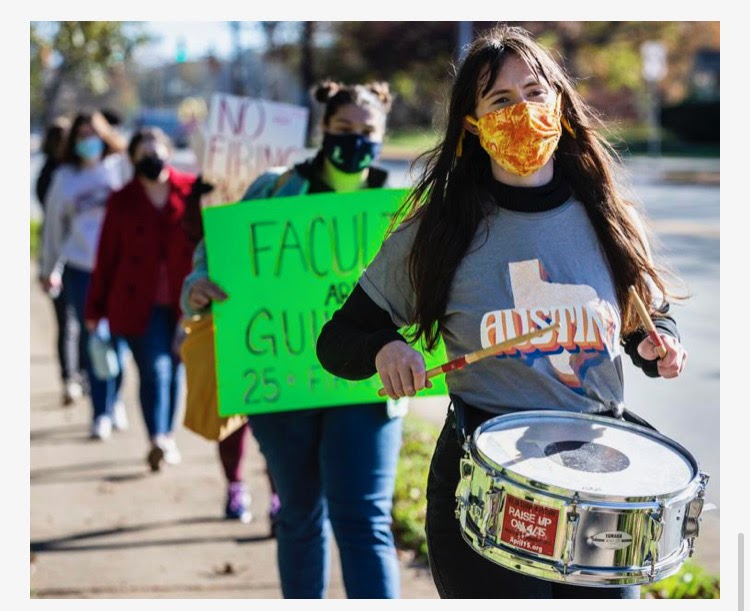 Haydyn+Foulke+leads+a+line+of+protestors+down+the+sidewalk+across+from+Guilford+campus.