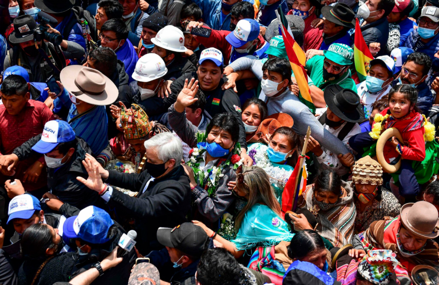 Evo Morales, center, is greeted by supporters as he returns to Bolivia.