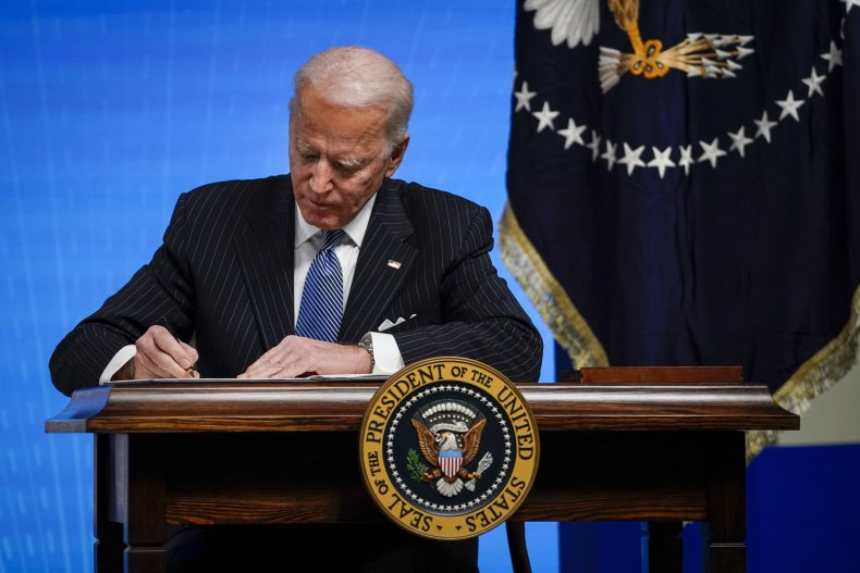 Newly elected President Joe Biden signs an executive order on Jan. 25, 2021.
