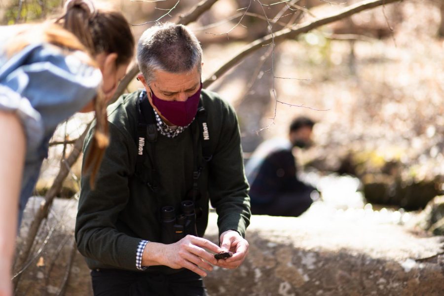 Jim Hood works with a student in his American Nature Writing course this spring during a class exploration in the Guilford Woods. 