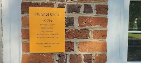 A poster announcing a flu shot and Pfizer COVID-19 booster shot clinic on campus. 