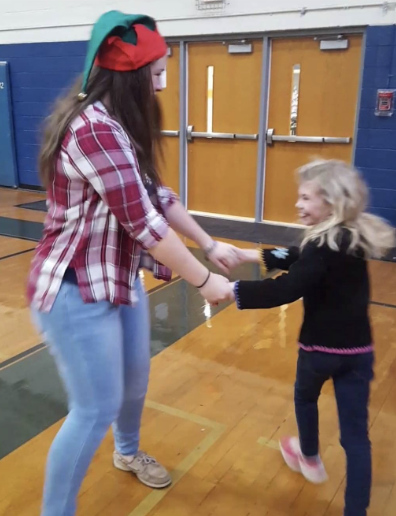 Guilford College sophomore Nikki Tuttle dances with a young guest at the Union County 4-H Exceptional Children’s Christmas party in 2017.