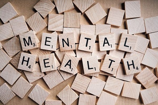 Mental health spelled out using wooden letter tiles.