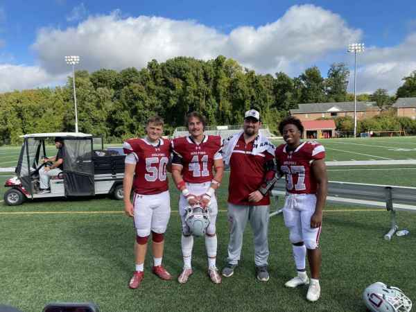 Guilford College football players Rod Hedrick, Avery Garner, Phil Couillard, and Josh Campbell at the Armfield Athletic Center.